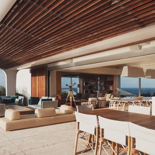 Sprawling ocean-view terrace with modern seating and dining areas creates your perfect outdoor retreat.