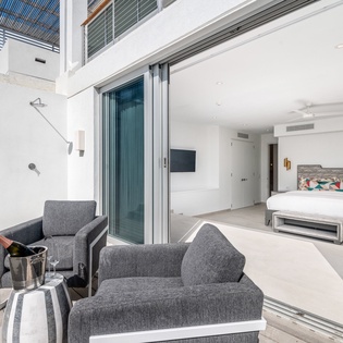 Relax in your modern bedroom suite with private terrace seating and seamless indoor-outdoor flow for the perfect tropical getaway.