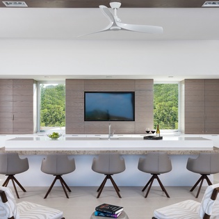 Your sleek kitchen island invites gathering with friends while you prepare meals and enjoy forest views through expansive windows.