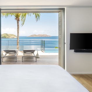 Wake up to breathtaking ocean views from your bed, with glass doors opening to a private terrace overlooking crystal-clear waters.