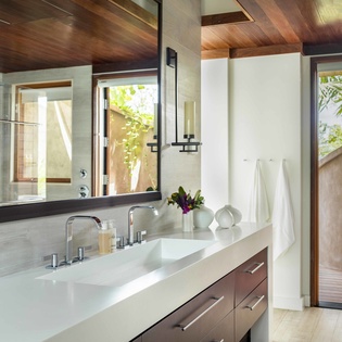 Indulge in your luxurious bathroom sanctuary with sleek modern fixtures, warm wood accents, and private outdoor access to your serene garden retreat.