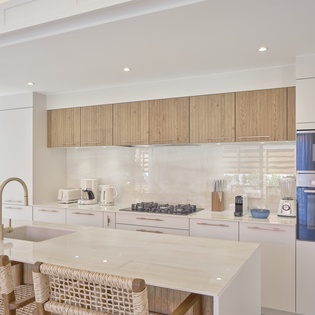 Your modern kitchen blends warm wood and white finishes with premium appliances, perfect for preparing meals together.