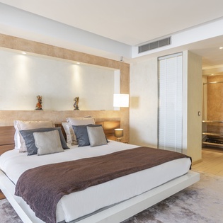 Sink into the plush bedding and modern design of your serene retreat, where warm wood tones and soft lighting create the perfect atmosphere for restful nights.