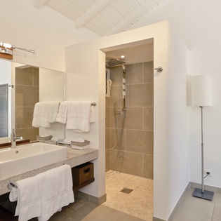 Step into your private spa-like bathroom with modern fixtures, fluffy towels, and a refreshing walk-in shower.