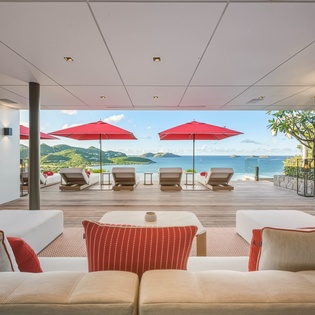 Sink into plush sofas and let the stunning ocean panorama captivate you through floor-to-ceiling windows in this breathtaking living space.