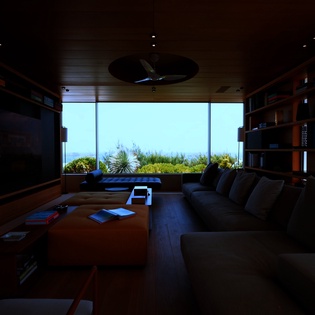 Sink into plush seating while ocean views stretch endlessly beyond floor-to-ceiling windows in your personal library retreat.