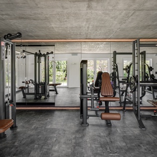 Elevate your fitness routine in this fully-equipped gym with professional-grade machines, free weights, and floor-to-ceiling windows for natural motivation.