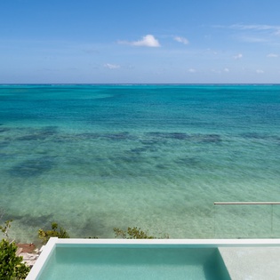 Pristine turquoise waters stretch endlessly before this oceanfront retreat with crystal-clear swimming pool and stunning sea views.