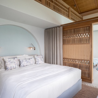 Drift off to sleep in your tranquil bedroom, where soft linens meet natural bamboo accents and gentle lighting creates the perfect sanctuary.