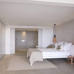 Your serene suite features an elegant bedroom with contemporary design and an open ensuite shower for ultimate relaxation.