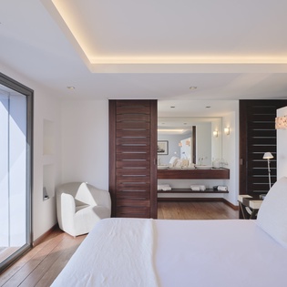 Unwind in your modern suite with floor-to-ceiling windows, plush bedding, and a sophisticated ensuite for ultimate relaxation.