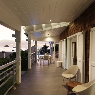 Your private covered terrace offers stylish seating and dining areas, perfect for morning coffee or evening relaxation while enjoying the peaceful surroundings.