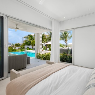 Wake up to tropical paradise from your bright bedroom overlooking the turquoise pool and swaying palms.