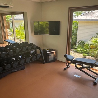 Stay fit during your getaway in this well-equipped fitness center, featuring free weights and exercise equipment with tropical garden views.