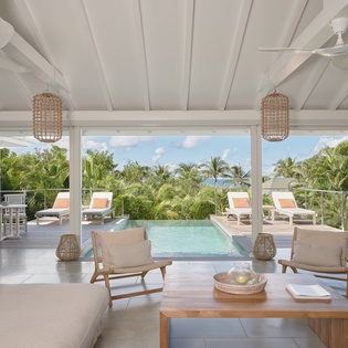 Relax in your bright living room where tropical breezes flow through open doors to your private pool paradise.