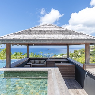 Soak in sunlit waters while gazing across endless blue ocean—your private infinity pool and bar pavilion await, perfectly framed by tropical breezes and island charm.