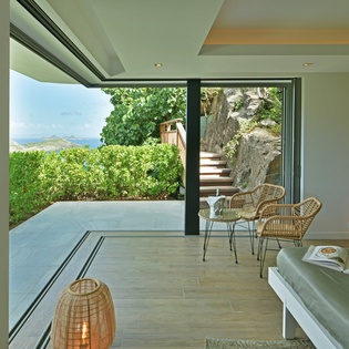 Your bright living space flows seamlessly to the garden terrace, where natural light streams through floor-to-ceiling windows, creating the perfect indoor-outdoor retreat.