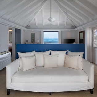Sink into the plush daybed and admire stunning ocean views framed perfectly in the window, while vaulted ceilings and coastal breezes make this your ultimate retreat.