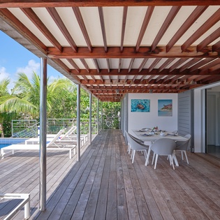 Your private outdoor terrace beckons with tropical views, pool access, and perfect shade for alfresco dining.