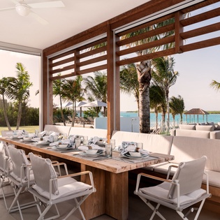 Dine in paradise where tropical views meet elegant comfort. Your oceanfront dining space opens to swaying palms and turquoise waters.