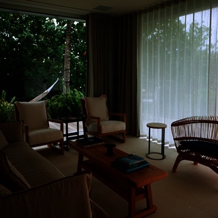 Unwind in your peaceful living space with garden views and a private outdoor hammock for ultimate relaxation.