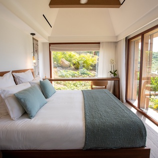 Wake up to forest views from your tranquil bedroom, where crisp linens and natural light create the perfect retreat.