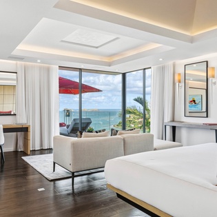 Wake up to breathtaking ocean views from your luxurious suite, where floor-to-ceiling windows frame endless blue horizons and modern comfort meets tropical paradise.