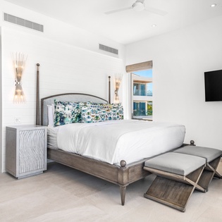 Unwind in your serene bedroom sanctuary, where crisp white linens and elegant furnishings create the perfect retreat for restful nights.