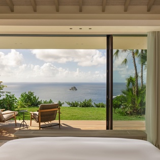 Wake to stunning ocean views from your bed, where tropical breezes drift through sliding doors onto your private terrace.