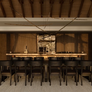 Gather around this stunning dining space where warm wood meets modern design, perfect for memorable meals with your group.