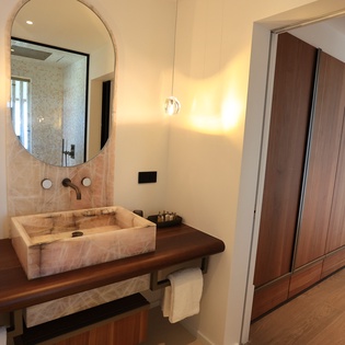 Your stylish ensuite features a stunning marble sink, elegant mirror, and generous wardrobe space for complete comfort.