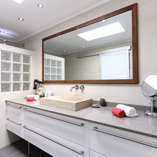 Pamper yourself in this elegant bathroom featuring a spacious vanity, premium amenities, and thoughtful touches like plush towels waiting for you.