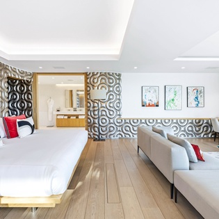 Your stylish suite combines sleeping and living spaces with bold geometric patterns, premium furnishings, and sleek modern design.