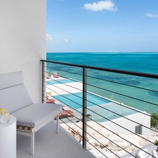 Sip your morning drink on this private balcony while turquoise Caribbean waters stretch endlessly before you, creating the perfect oceanfront retreat.