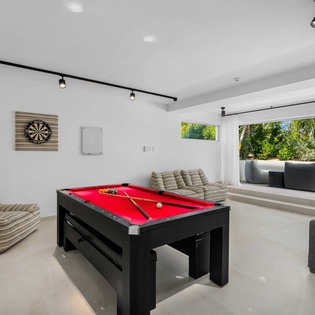 Challenge friends to pool and darts in your stylish game room, then step out to your private terrace with tropical views.