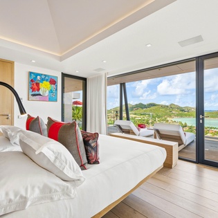 Wake up to breathtaking ocean views from your luxurious bed, where panoramic windows frame tropical paradise.
