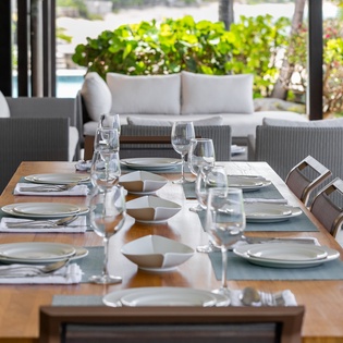 Your private dining space awaits, set with elegant place settings and serene garden views—perfect for memorable meals together.