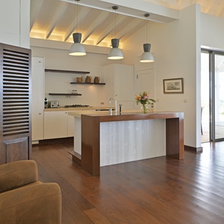 Your modern open-concept retreat features soaring beamed ceilings, sleek pendant lighting, and a stunning kitchen island perfect for gathering.