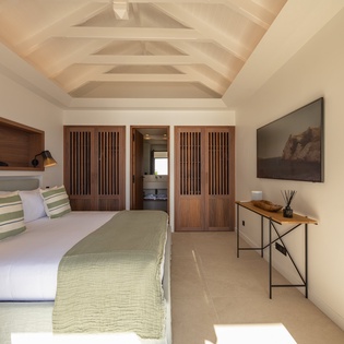 Unwind in your serene retreat with vaulted ceilings and warm wood accents creating the perfect peaceful sanctuary.