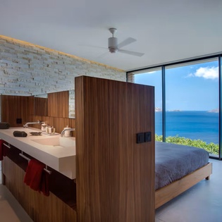 Wake to breathtaking ocean views through floor-to-ceiling windows in this modern coastal sanctuary. Open-concept design blends contemporary style with serene seaside living for an unforgettable getaway.