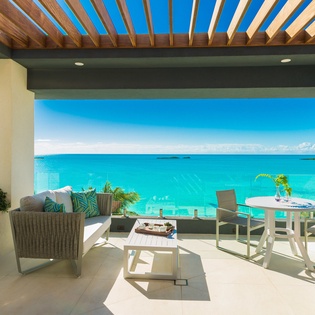 Your private terrace overlooks endless turquoise water, perfect for morning coffee or sunset dining in paradise.