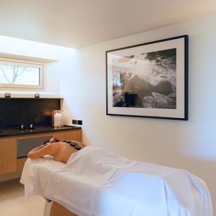 Indulge in pure relaxation during your rejuvenating spa treatment in this serene, beautifully appointed massage room.