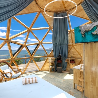Wake up to breathtaking ocean views through your private geodesic dome's panoramic windows—a one-of-a-kind sanctuary where modern design meets nature's beauty.