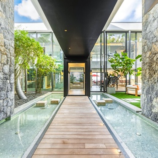 Walk across the elegant wooden bridge over crystal-clear water as you enter this stunning contemporary retreat.