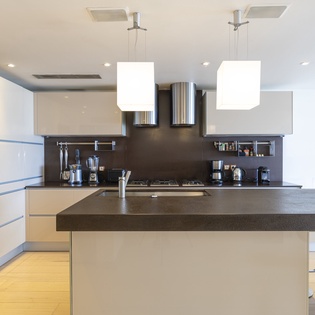 Your sleek, fully equipped kitchen awaits with modern appliances, a spacious island, and plenty of counter space for preparing meals together.