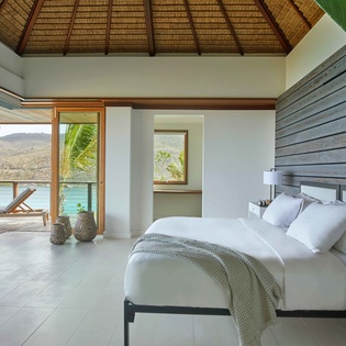 Wake up to breathtaking ocean views from your tropical bedroom sanctuary with pristine linens and stunning natural light.