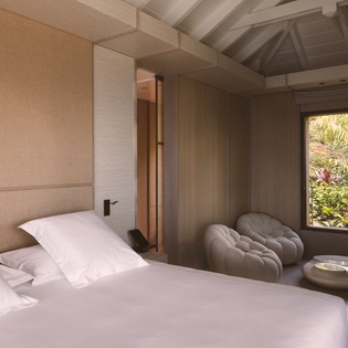 Unwind in your serene retreat where natural wood beams frame peaceful garden views from your private sanctuary.