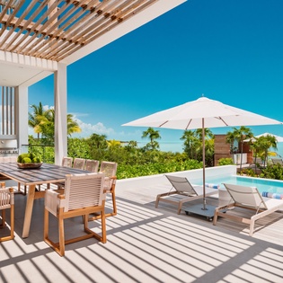 Relax on your private deck with poolside dining and loungers, where tropical views meet modern luxury comfort.