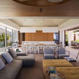 Unwind in this stunning open-concept space where modern comfort meets warm wood accents, perfect for memorable gatherings.