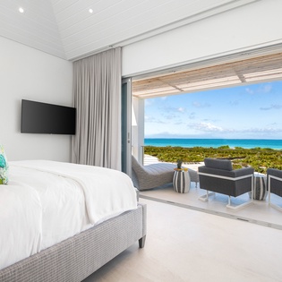 Wake up to breathtaking ocean views from your private bedroom sanctuary, where turquoise waters stretch endlessly beyond your terrace.